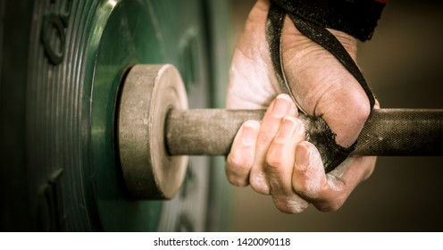 Preparing for snatch: barbell hook grip in a gym - Shutterstock ID 1420090118