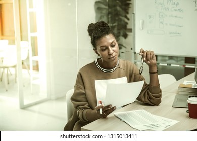 Preparing speech. African-American office worker wearing casual clothes feeling busy preparing her speech