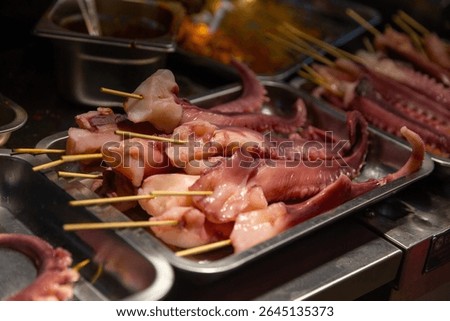 Preparing Squid to be BBQ in China Town as a snack