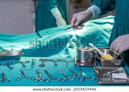 Preparing surgical instruments, scissors, doctor's hand, wearing surgical gloves in the hospital operating room 