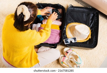 Preparing For Travel In New Normal. Woman Packing Clothes In Luggage For New Journey, Preparation Travel Suitcase At Home, Travel Vacation Traveling After Quarantine Coronavirus Pandemic Concept