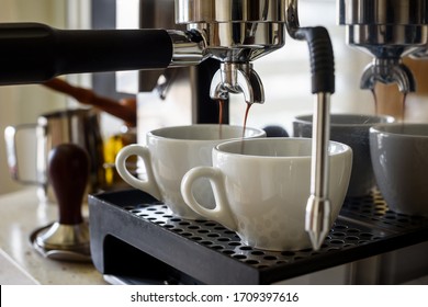 Preparing two cups of coffee on an espresso machine. - Shutterstock ID 1709397616