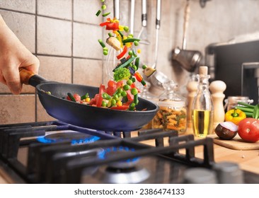 Preparing Various chopped vegetables in a frying pan over the gas stove for evening dinner at home kitchen - Powered by Shutterstock