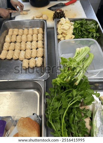 Preparing vegetable soup with mustard leaf, pineaple, gish cake, and celery.