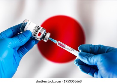 Preparing vial of medicament for the vaccination of Coronavirus cure In Japan. Injecting dose of vaccine in syringe for Covid-19 over the Japanese flag - Powered by Shutterstock