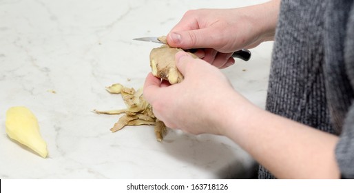 Preparing a warming drink with ginger, lemon and honey.