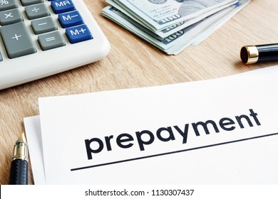 Prepayment. Document, calculator and dollars on a desk.