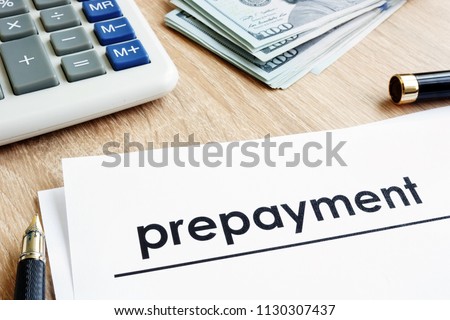 Prepayment. Document, calculator and dollars on a desk.