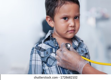 A Preschool Age Boy Getting A Heart Screening, Using A Stethoscope On Chest With A Buttoned Down Shirt.