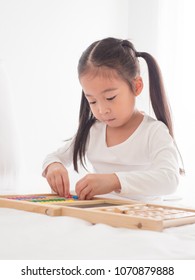 preschool age little Asia children play with colorful plastic toy blocks.Child playing with building blocks learning new skills.