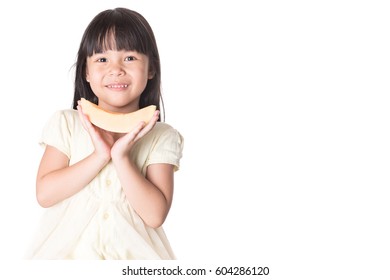 Preschool Age Little Girl Eating A Slice Of Cantaloupe