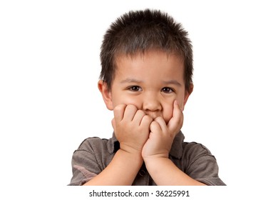 Preschool Aged Boy With His Hand/fists Over His Mouth; Looking Embarrassed, Worried Or Unsure. Isolated On White.