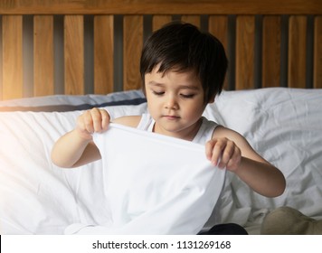 Preschool Boy Sitting In Bed And Try To Wearing White T-Shirt In Vintage Filter,Cute Kid Boy Getting Dressed And Get Ready For School,Child Dressing Uniform In Bed Room Ready To School