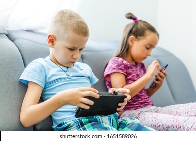 Preschool boys playing on smartphone