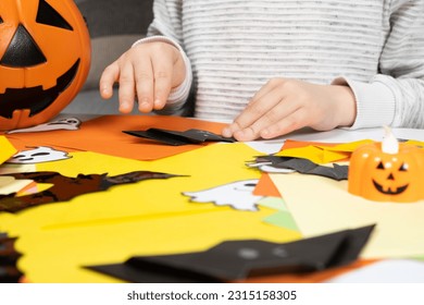 Preschool child creates Halloween origami paper bat crafts, close-up hands - Shutterstock ID 2315158305