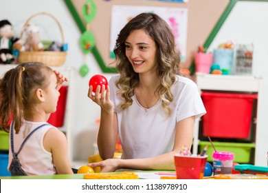 Preschool Child And Teacher In Classroom