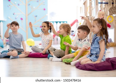 Preschool children play on speech therapy lesson in kindergarten or primary school
