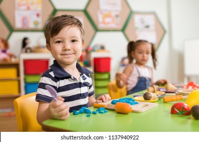 Preschool Children And Teacher In Classroom