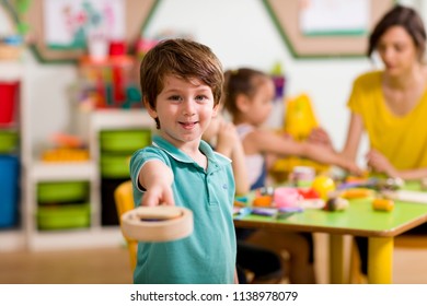 Preschool Children and Teacher in Classroom - Shutterstock ID 1138978079