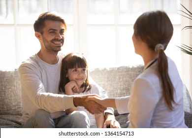 Preschool daughter with father having visit paediatrics parent and doctor woman shaking hands greeting each other. Concept of pediatrics medicine care of children, medical insurance health examination - Powered by Shutterstock