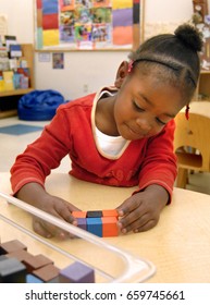 Preschool  Girl In The Head Start Early Childhood Education, Health, And Nutrition Program, Playing With Blocks, New York, New York, April 6, 2015