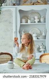 A Preschool Girl Holds A Cookie Jar In A Vintage Dining Room. Retro Interior.