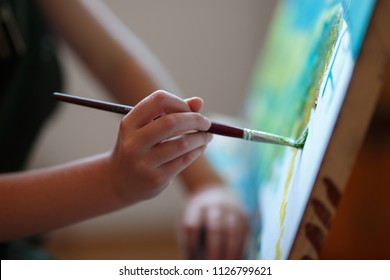 Preschool Girl Painting In Art Class. Close Up Photo Brush In Hand