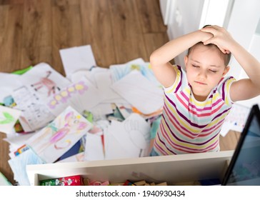 A Preschool Girl Tidies Up The Dresser In Her Room. A Child Among A Mess Of A Heap Of Papers, Sheets And Drawings