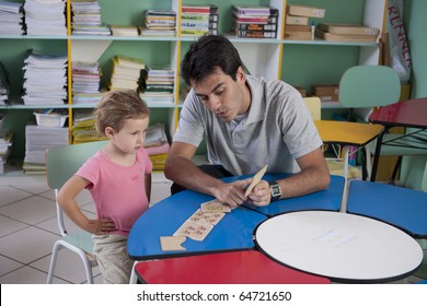 Preschool Teacher And Child In The Classroom Counting