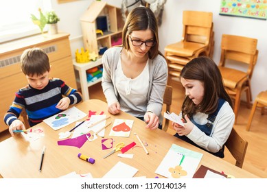 Preschool Teacher With Children At Kindergarten - Creative Art Class