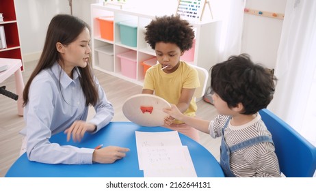 Preschool teacher with children study in classroom. Kindergarten back to school and summer course.