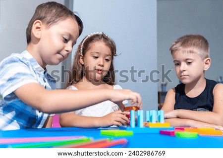 Preschool-aged children immerse themselves in captivating tasks, solving logic puzzles, and refining fine motor skills during engaging developmental sessions. Kids studying in classroom