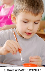 Preschooler Boy 4 Years Old Drawing In Classroom