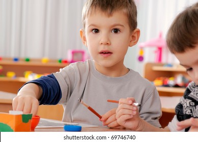 Preschooler Boy 4 Years Old Drawing In Classroom