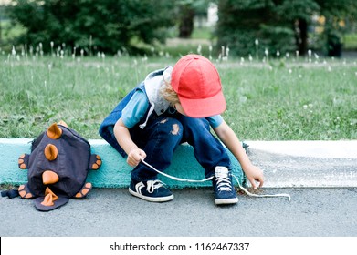 Preschooler Boy Learning To Tie His Shoes.