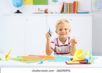 Preschooler Boy Making Colorful Origami