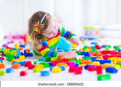 Preschooler Child Playing With Colorful Toy Blocks. Kids Play With Educational Toys At Kindergarten Or Day Care. Preschool Children Build Tower With Plastic Block. Toddler Kid In Nursery.