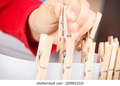 Preschooler Playing With Wooden Clip. Development Of Kids Motor Skills, Coordination, Creativity And Logical Thinking