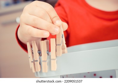 Preschooler Playing With Wooden Clip. Development Of Kids Motor Skills, Coordination And Creativity