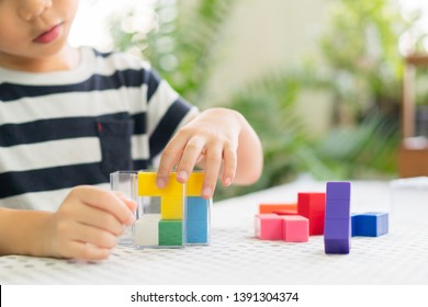 Preschooler Plays Colorful Block Puzzle. Child Development -Hands-on Activities Developing Problem Solving Skill, Cognitive Skill, Concentration And Emotional Intelligence. Learn Through Play Concept.