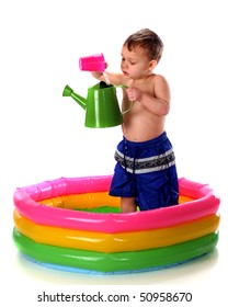 A Preschooler Pouring Water From A Plastic Cup To A Watering Can While Standing In A Colorful Kiddie Pool.  Isolated On White.