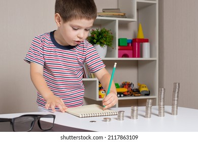 A Preschooler's Child Records And Calculates Financial Expenses. Literacy For Children, Coins.