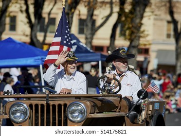 Prescott, Arizona, USA - November 11, 2016: Two Korean War Veterans Driving A Jeep Participating In The Veteran's Day Parade And Waving