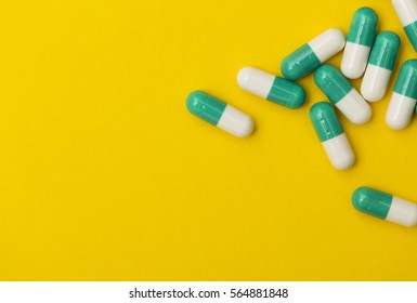 Prescription antibiotic drug medication pills on a bright colourful background. Health care concept