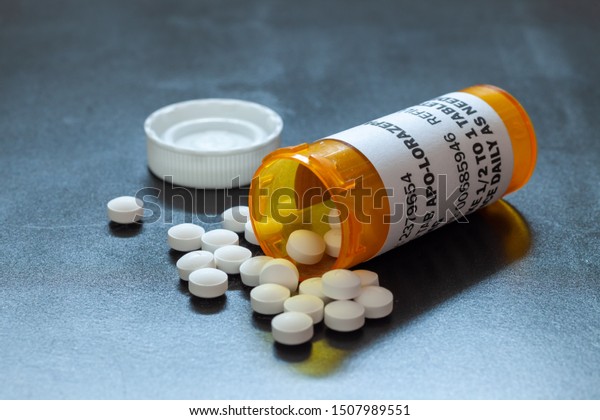 Prescription bottle with backlit Lorezapam\
tablets. Lorezapam is a generic prescription anti-anxiety\
medication. A concept for mental\
health.