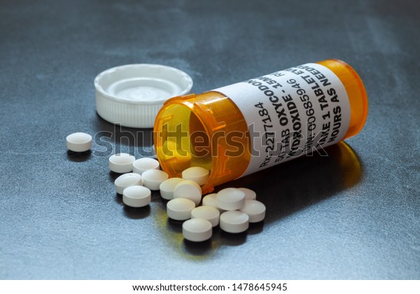 Prescription bottle with backlit Oxycodone\
tablets. Oxycodone is a generic prescription opioid. A concept of\
the opioid epidemic\
crisis