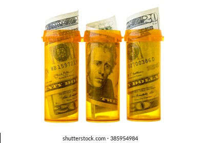 Prescription Drug Bottles With Twenty Dollar Bills Inside, Isolated On White