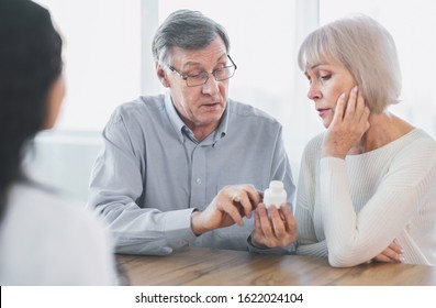 Prescription Medication. Confident Senior Man Pointing At Bottle, Reading Instructions, Asking Doctor A Question