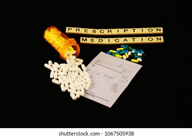 Prescription Medication Spelled Out With Tiles, Spilled Prescription Pills On A Prescription Pad On A Black Background