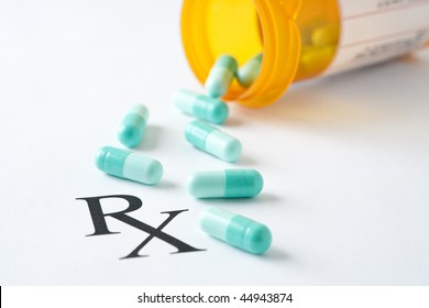 Prescription Medicine And Bottle On Paper With RX Symbol